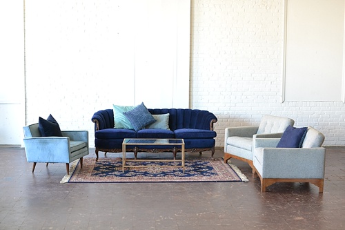 Vintage and eclectic lounge areas styled with monochromatically colored upholstered furniture available for rent for weddings and events by Paisley & Jade 
